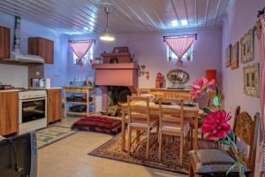 a kitchen with a wooden table and a dining room at Minodora's Guesthouse in Dikorfo