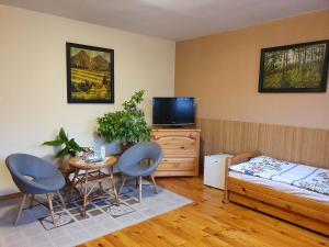a bedroom with a bed and a table and chairs at Penzión U Jakuba in Kežmarok