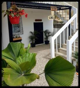 a house with a staircase and a plant in front of it at Stop and Chill in Playas