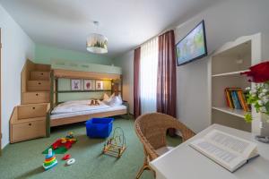 オーバーキルヒにあるランドホテル サルメンのベッドルーム1室(ベッド1台、デスク、テーブル付)