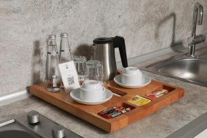 a wooden tray with cups and dishes on a kitchen counter at Meroddi Galata Flats in Istanbul