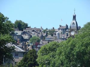 a city with a clock tower and a town at Courtyard Flat - Kendal in Kendal