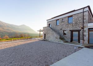 a stone house with a view of the mountains at Tenuta San Martino in Nusco