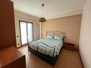 a bedroom with a bed and a large window at Dreamy home in Ateleta