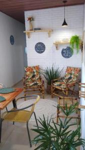 a patio with chairs and a table and a table and chairs at Aconchego de Itapuã in Salvador