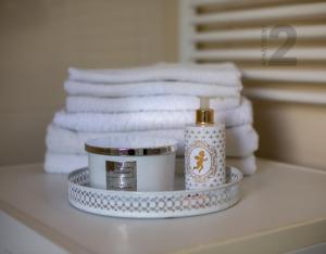 a bathroom counter with towels and a bottle of soap at Apartments Kaya in Pula