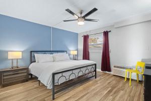 a bedroom with a bed and a ceiling fan at Sunset Beach Suite 2 in St. Pete Beach