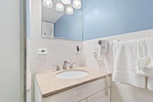 a bathroom with a sink and a mirror at Sunset Beach Suite 2 in St Pete Beach