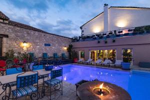 a swimming pool with chairs and a building at LA VILLA in Terraube