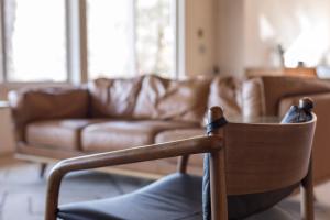 a chair in a living room with a couch at The Edelweiss Estate in Gatlinburg