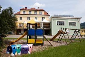 un parque infantil frente a una casa grande en Gasthof Schattleitner, en Brückl