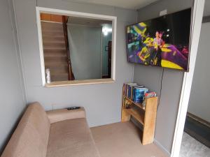 a living room with a tv on a wall at Catema in Coihaique