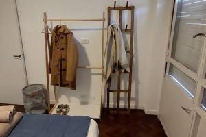 a room with a bed and a ladder and a closet at A metros del Parana - Centro in Rosario