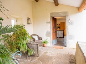 a hallway of a house with chairs and plants at Gite Mas Sophia in Labeaume