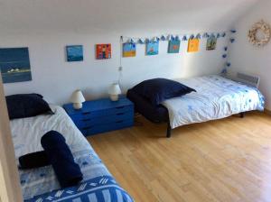 a bedroom with two beds and a blue dresser at Les Joncades - Maison de vacances in Saint-Gildas-de-Rhuys