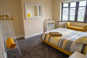 a bedroom with a bed and a ladder and a mirror at Spacious Family Home Minutes from the Beach in Blackpool