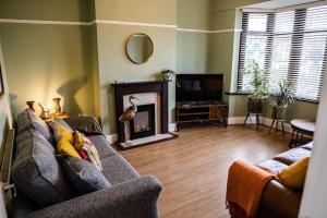 a living room with a couch and a fireplace at Spacious Family Home Minutes from the Beach in Blackpool