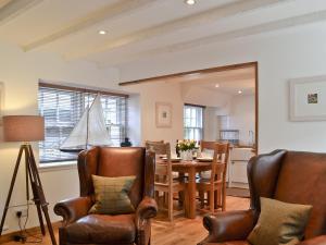 a kitchen and dining room with a table and chairs at Tides in Cromarty