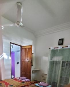 a room with a bed and a door and a mirror at Busy Bee Apartments in Kololi +112 photos
