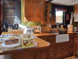 a kitchen counter with a tray of dishes on it at Brook Barn in Ellingham