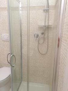 a shower with a glass door and a toilet at IN CENTRO in Porto SantʼElpidio