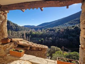 a view from the window of a stone building at Les clapiers appartement avec jacuzzi et rivière. in Mialet