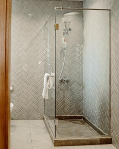 a shower with a glass door in a bathroom at BirdNest at Sheikh Zayed in Sheikh Zayed +50 photos