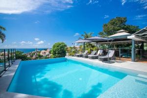 a swimming pool with a view of the ocean at Karibea Squash Hôtel in Fort-de-France