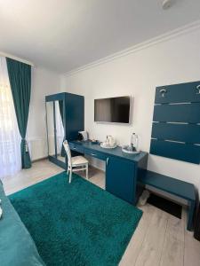 a hotel room with a blue desk and a bed at Casa Hera in Sinaia
