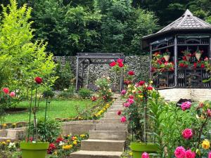 a garden with a gazebo and flowers at Casa Hera in Sinaia