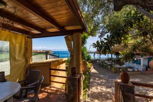 a patio with a view of the ocean at Villaggio Residence Pietra Grigia in Marina di Camerota