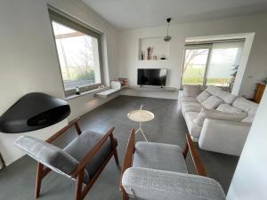 a living room with a couch and chairs and a table at Casa Luce in Torre di Palme