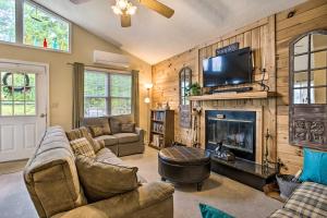 a living room with a couch and a fireplace at Cozy North Carolina Abode - Deck, Grill and Fire Pit in Burnsville