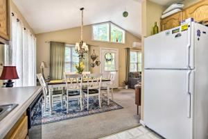 a kitchen and dining room with a white refrigerator at Cozy North Carolina Abode - Deck, Grill and Fire Pit in Burnsville
