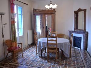 a dining room with a table and chairs and a fireplace at Maison Collioure, 4 pièces, 6 personnes - FR-1-225-684 in Collioure