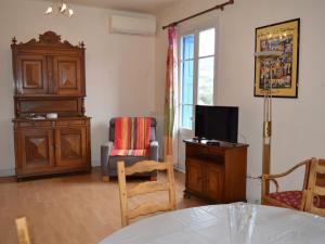 a living room with a tv and a chair at Maison Collioure, 4 pièces, 6 personnes - FR-1-225-684 in Collioure