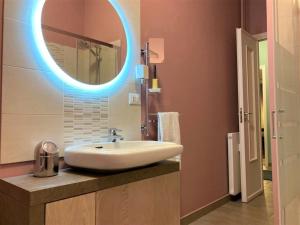 a bathroom with a sink and a blue light at Casa Torino Liberty in Turin