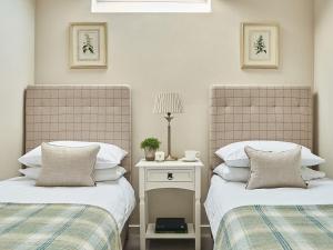 two beds sitting next to each other in a bedroom at Rosedale in Pickering