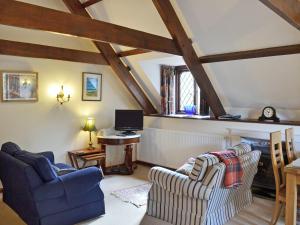 a living room with two chairs and a desk at The Manor Wing in Par