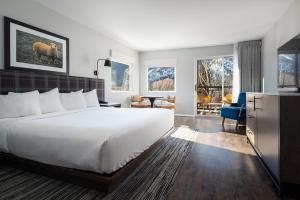 a hotel room with a bed and a living room at Hotel Ketchum in Ketchum