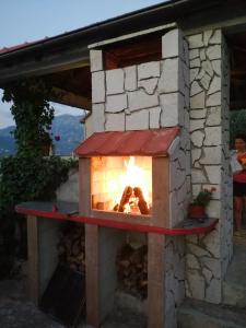 a brick oven with a fire in it at INO Apartments in Tivat