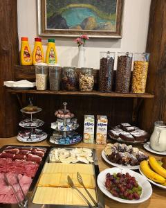 a table with many different types of food on it at Penzion Panský dům in Kvilda