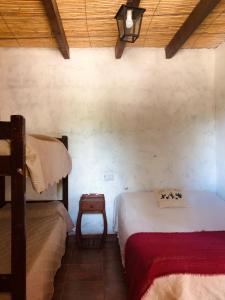 a bedroom with two beds in a room with a ceiling at Matices de Molinos Hostal in Molinos