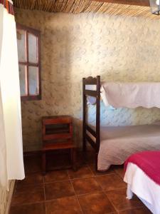 a bedroom with two bunk beds and a window at Matices de Molinos Hostal in Molinos
