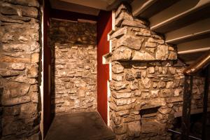 a stone room with a stone wall and a staircase at Como Unique View - byMyHomeinComo in Como
