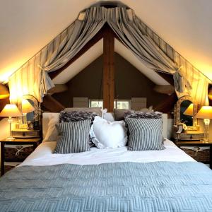 a bedroom with a large bed with a canopy at The Old Parlour at Cheshire Boutique Barns in Nantwich