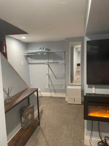 a living room with a tv and a fire place at Downtown Suite - Close to Topgolf, Horseshoe Casino, UM Baltimore in Baltimore