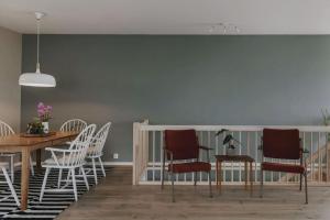 a dining room with a table and chairs at Fabrikken in Bleik +19 photos