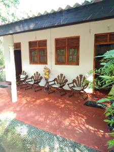 a group of chairs in front of a house at New Cinnamon Garden in Weligama