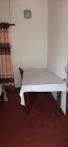 a table with a white cloth on it in a room at New Cinnamon Garden in Weligama